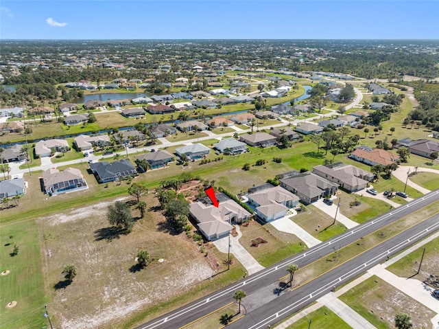 drone / aerial view featuring a water view and a residential view