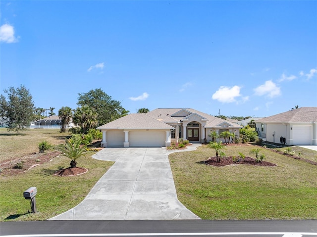 view of front of property featuring a garage, driveway, a front lawn, and stucco siding