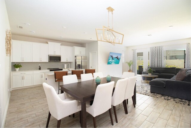 dining room with a chandelier and wood tiled floor