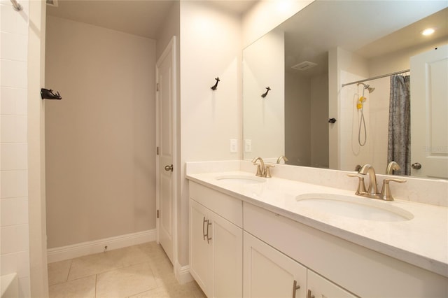 full bathroom with baseboards, a shower with curtain, a sink, and tile patterned floors