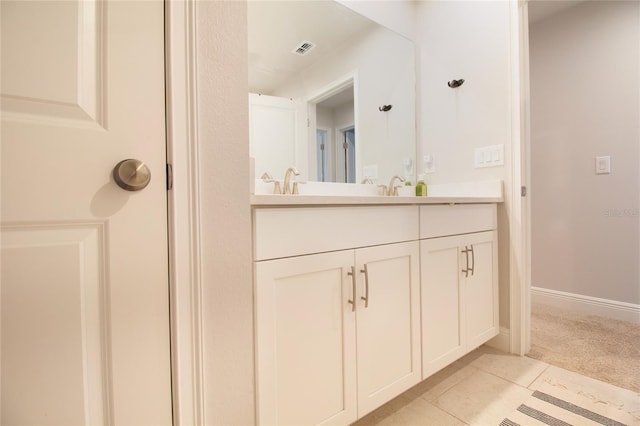 full bath with visible vents, vanity, baseboards, and tile patterned floors