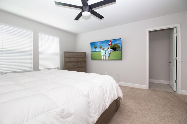 carpeted bedroom featuring ceiling fan and baseboards