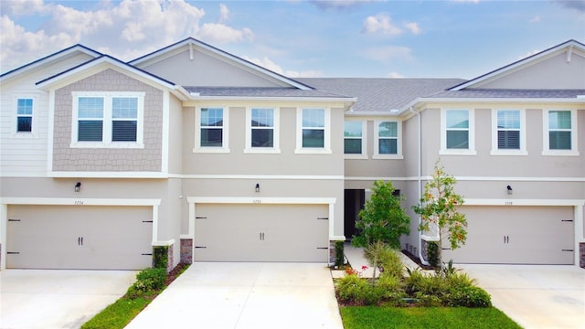 multi unit property with driveway and stucco siding