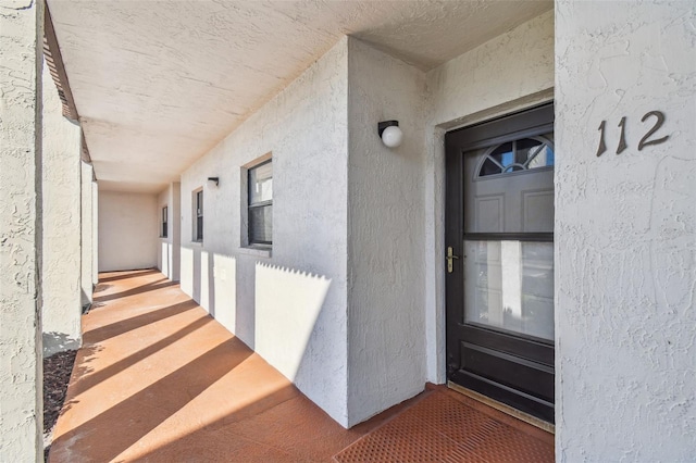 entrance to property with stucco siding