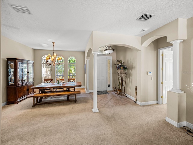 dining room with light carpet, visible vents, and ornate columns