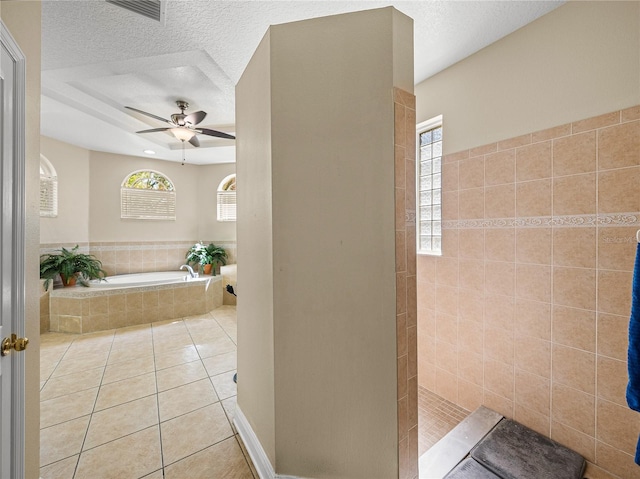 bathroom featuring visible vents, tile patterned floors, a garden tub, a textured ceiling, and a walk in shower