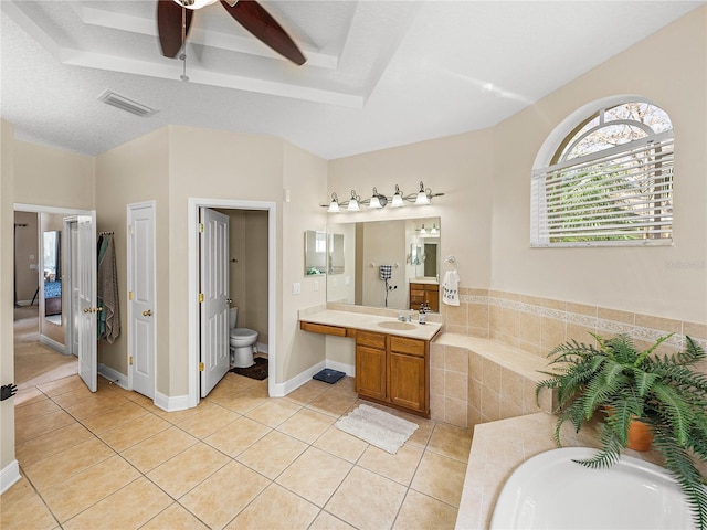 bathroom with a garden tub, visible vents, toilet, vanity, and tile patterned floors