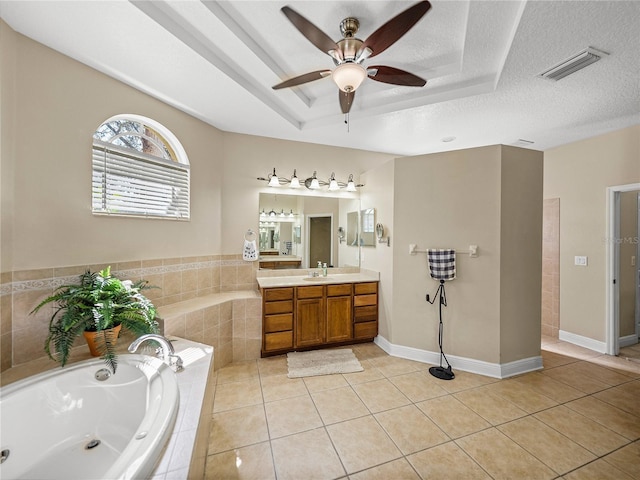 bathroom with visible vents, a raised ceiling, tile patterned flooring, a textured ceiling, and vanity