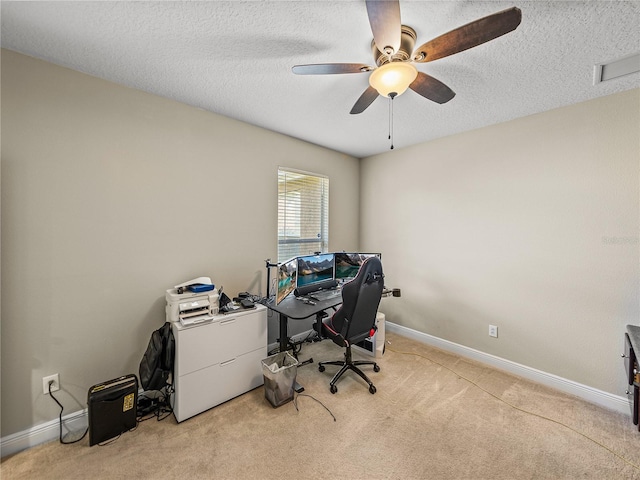 office space with a textured ceiling, carpet, and baseboards