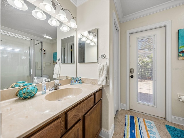 full bathroom featuring tile patterned flooring, vanity, baseboards, ornamental molding, and a shower stall