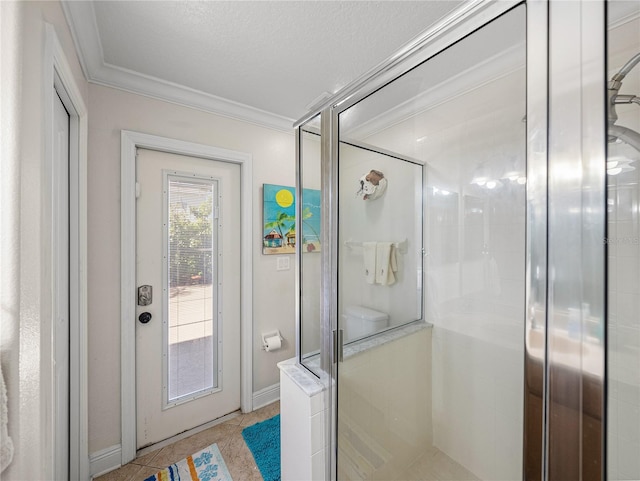 full bathroom with a textured ceiling, tile patterned flooring, baseboards, ornamental molding, and a stall shower