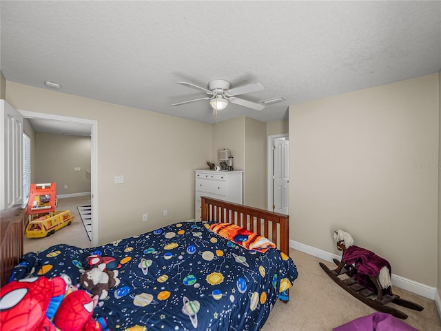 carpeted bedroom featuring a textured ceiling, visible vents, and baseboards