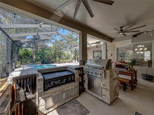 view of patio featuring glass enclosure, ceiling fan, grilling area, and area for grilling