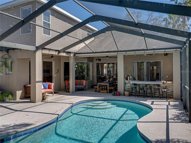 outdoor pool featuring a patio area and glass enclosure