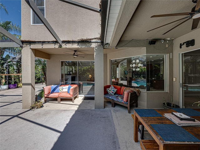 view of patio / terrace with a lanai, outdoor lounge area, and ceiling fan