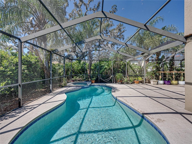 view of pool with a patio, a lanai, and a pool with connected hot tub