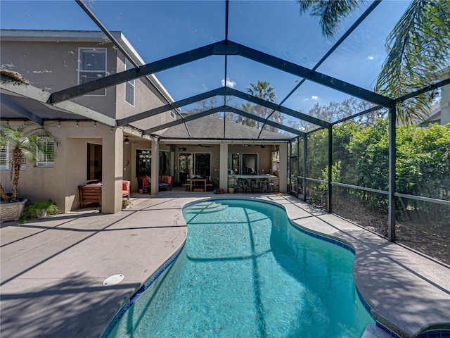 outdoor pool with ceiling fan, a lanai, an outdoor hangout area, outdoor dry bar, and a patio area