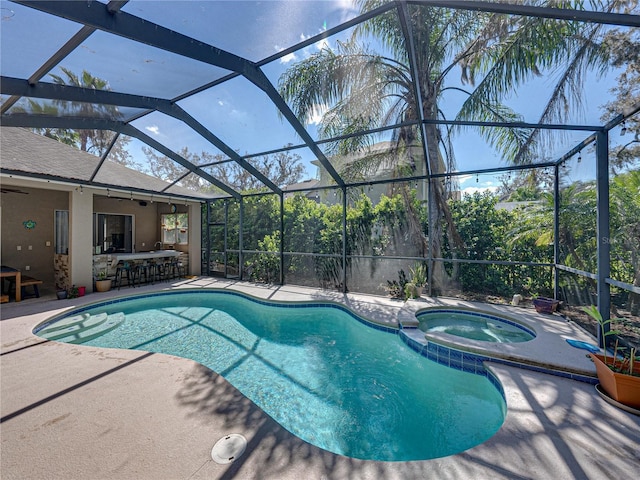 view of swimming pool with a lanai, a patio area, a pool with connected hot tub, and outdoor dry bar