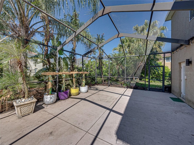 view of patio featuring a lanai