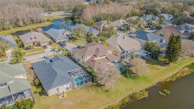 drone / aerial view featuring a residential view and a water view