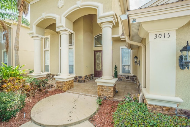 property entrance with stucco siding