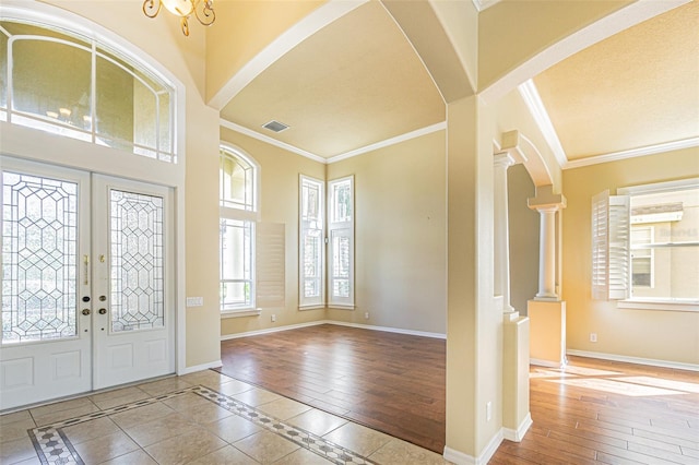 foyer featuring baseboards and ornamental molding