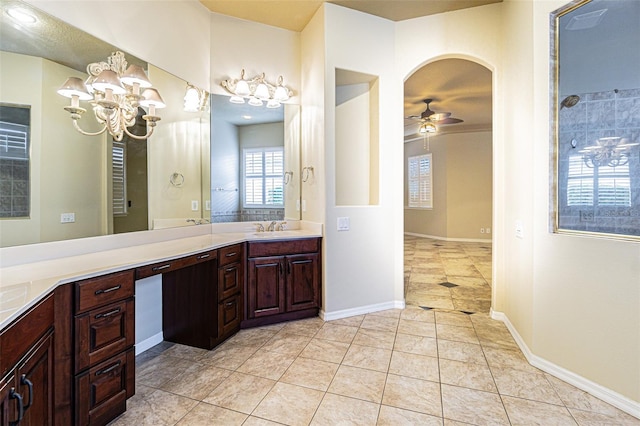 bathroom with ceiling fan with notable chandelier, vanity, baseboards, a shower, and tile patterned floors