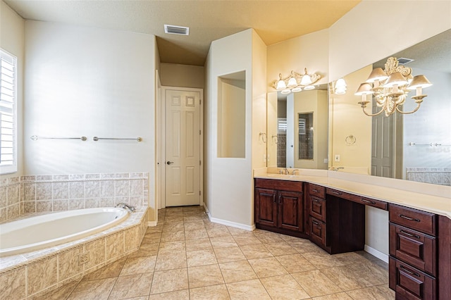 bathroom with a bath, plenty of natural light, vanity, and visible vents