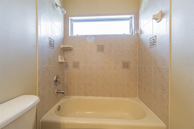 full bath with a textured wall, shower / bathing tub combination, plenty of natural light, and toilet