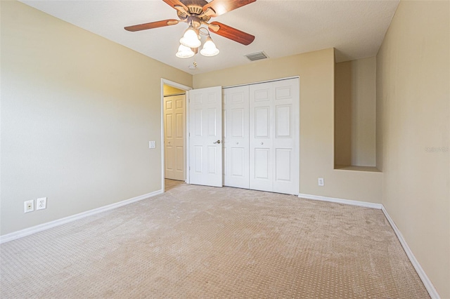 unfurnished bedroom featuring carpet floors, visible vents, and baseboards