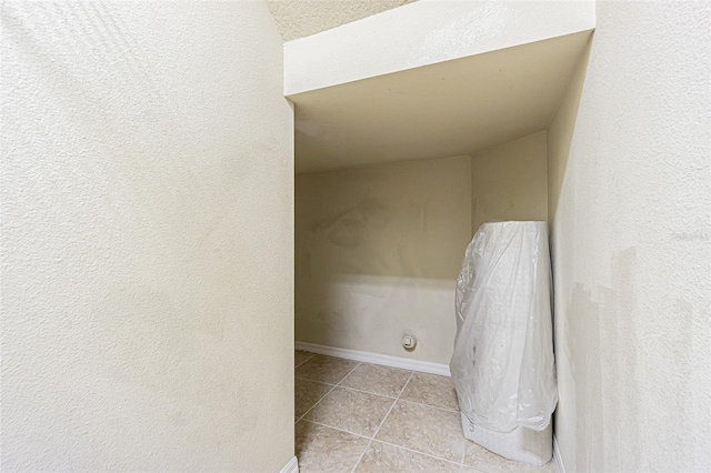 interior space featuring tile patterned flooring and baseboards