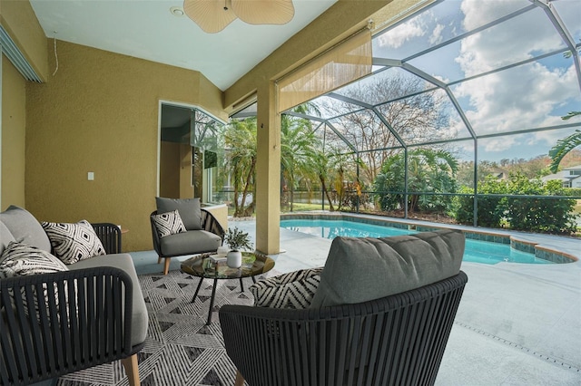 outdoor pool featuring a lanai, a patio area, ceiling fan, and an outdoor hangout area