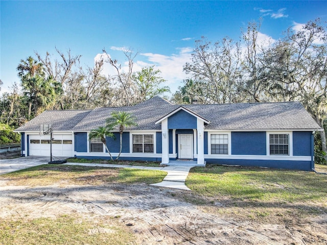 ranch-style home featuring a garage, a shingled roof, driveway, stucco siding, and a front yard