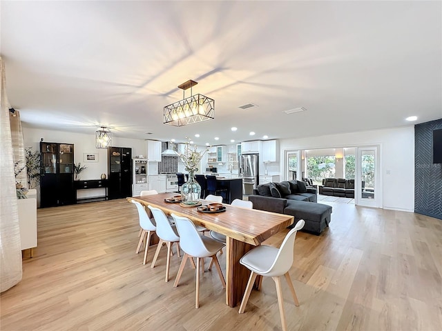 dining space featuring light wood-type flooring, visible vents, and recessed lighting