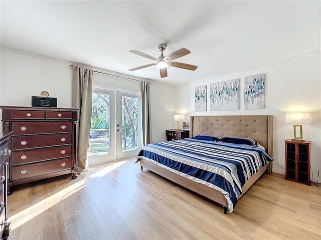 bedroom featuring light wood finished floors, access to outside, ceiling fan, and french doors