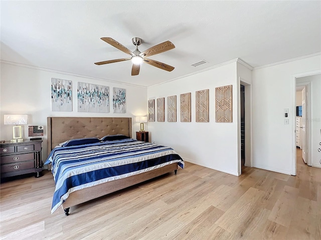 bedroom featuring visible vents, ornamental molding, a ceiling fan, wood finished floors, and baseboards