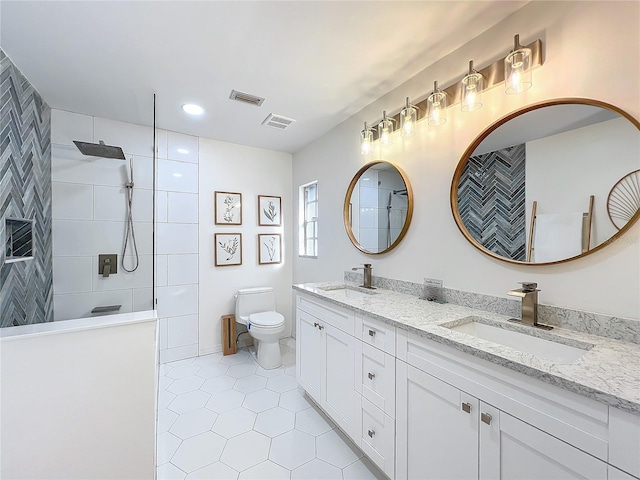 full bath with visible vents, a sink, toilet, and walk in shower