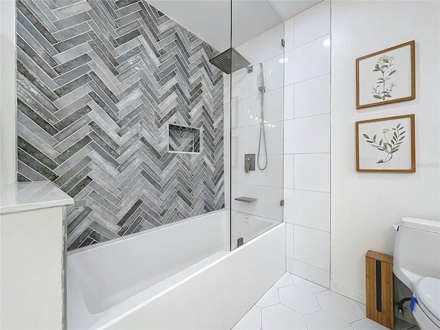 bathroom featuring bathing tub / shower combination, toilet, and tile patterned floors