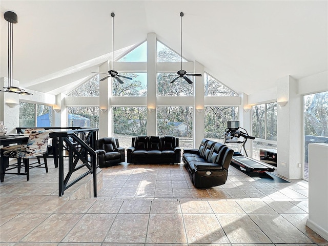 living room featuring plenty of natural light, high vaulted ceiling, and ceiling fan