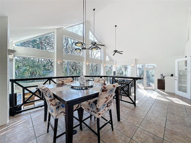 dining space featuring light tile patterned floors, high vaulted ceiling, plenty of natural light, and a ceiling fan