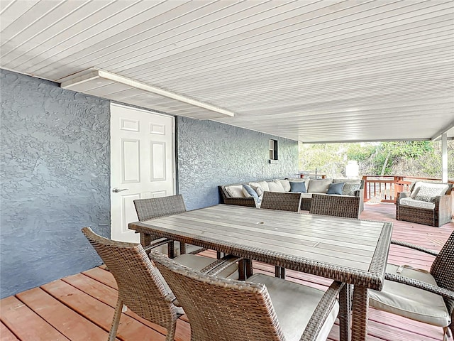 wooden deck featuring outdoor dining area and an outdoor living space