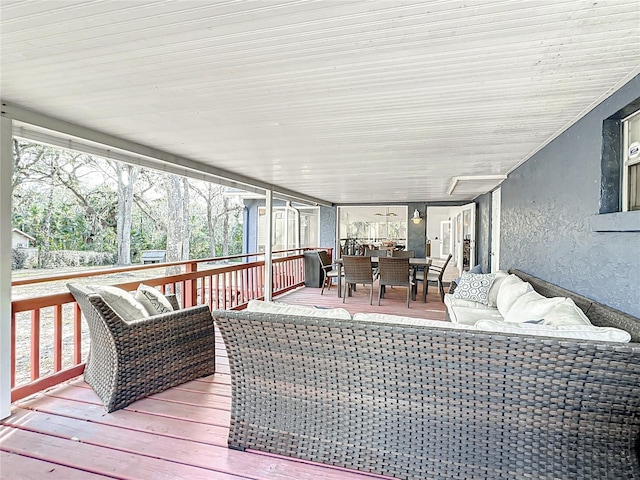 wooden deck featuring outdoor dining space and an outdoor living space