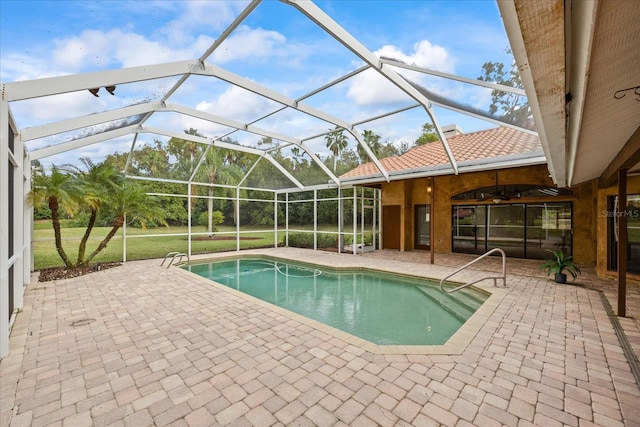 pool featuring glass enclosure and a patio area