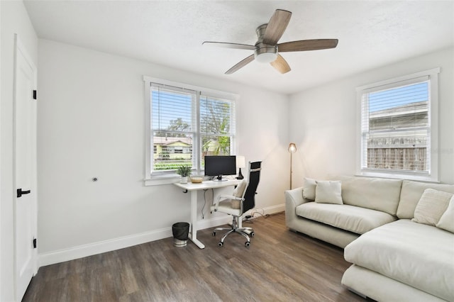 home office with plenty of natural light, wood finished floors, a ceiling fan, and baseboards