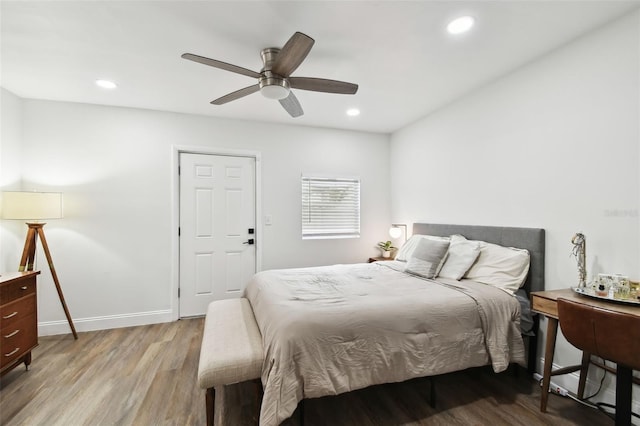 bedroom with ceiling fan, baseboards, wood finished floors, and recessed lighting