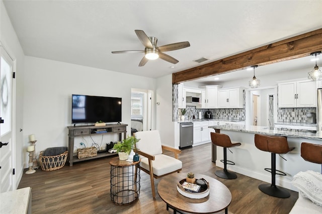 living area featuring baseboards, visible vents, a ceiling fan, dark wood-style flooring, and beam ceiling