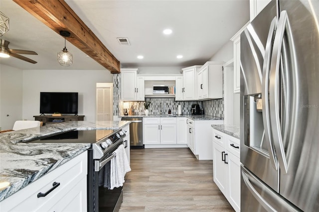 kitchen with stainless steel appliances, visible vents, light wood-type flooring, backsplash, and beam ceiling