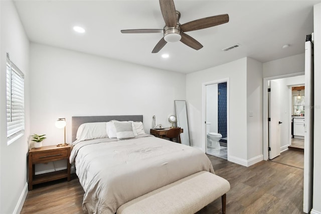 bedroom featuring baseboards, visible vents, wood finished floors, and recessed lighting