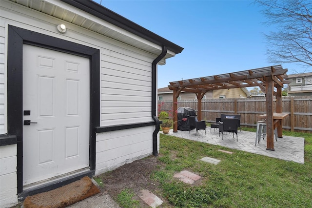 doorway to property featuring a lawn, fence, a pergola, and a patio