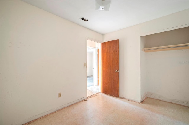 unfurnished bedroom featuring a closet and visible vents